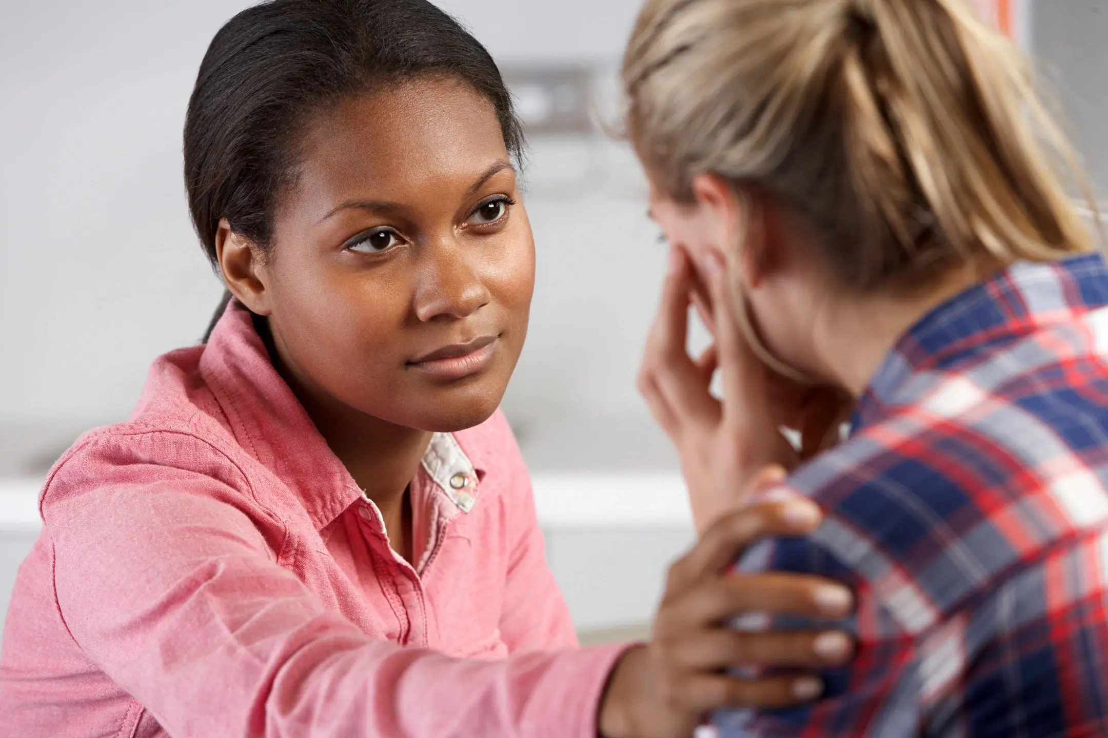 A woman is talking to another person in front of her.